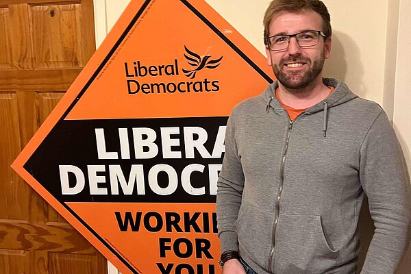 Pele stood in front of Lib Dem stake board